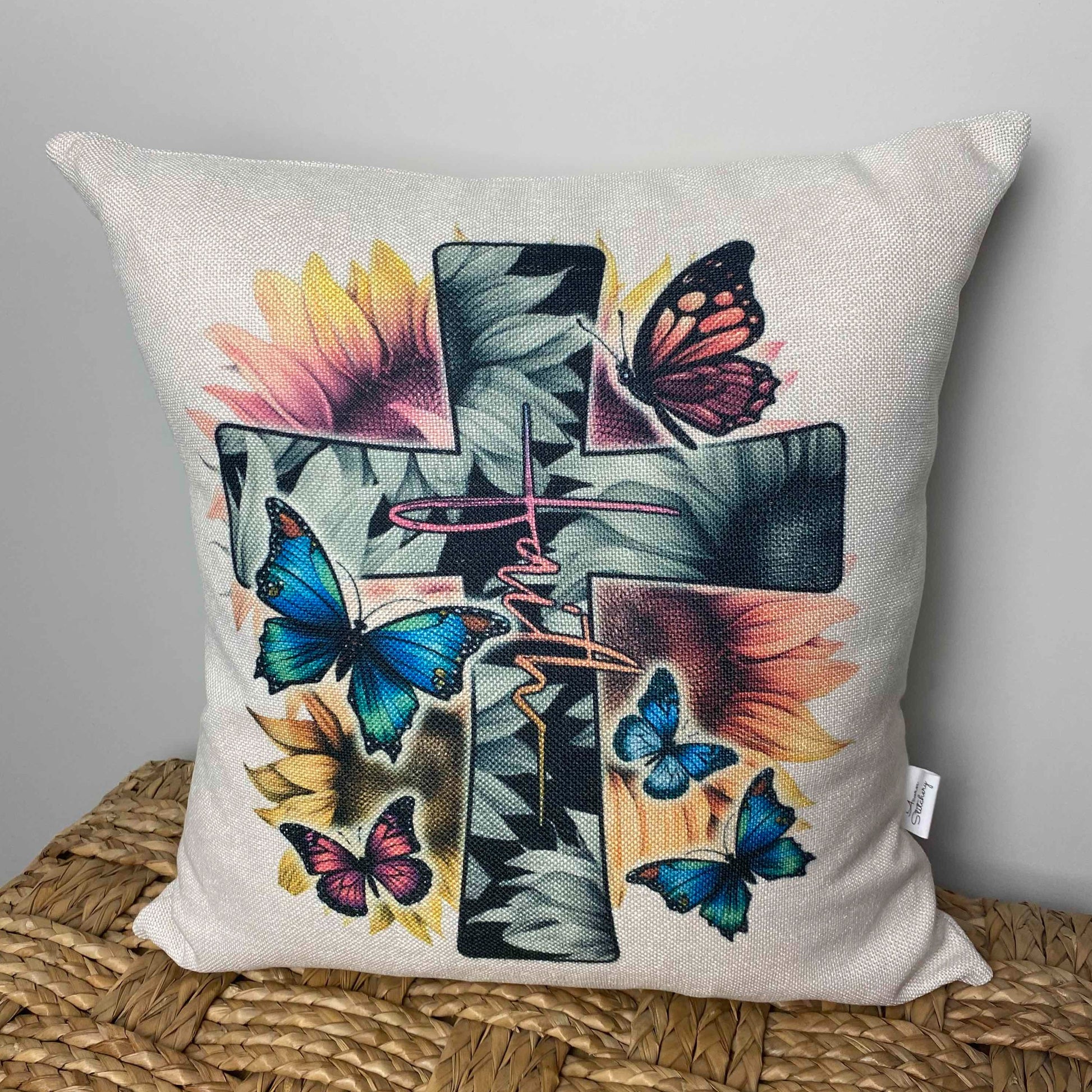 cross with butterflies and the word Faith on a pillow
